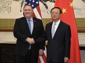 FILE - In this Monday, Oct. 8, 2018, file photo, U.S. Secretary of State Mike Pompeo, left, shakes hands with Yang Jiechi, a member of the Political Bureau of the Chinese Communist Party, before a meeting at the Diaoyutai State Guesthouse in Beijing. Pompeo and Defense Secretary Jim Mattis will meet Friday, Nov. 9 with their counterparts Jiechi and Wei Fenghe at the State Department.