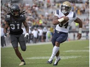 File-This Nov. 10, 2018, file photo shows Navy fullback Mike Martin (34) rushing for a 14-yard touchdown in front of Central Florida defensive back Aaron Robinson (31) during the second half of an NCAA college football game in Orlando, Fla. Although Navy is having a down year, it snapped a seven-game skid with a 37-29 win over Tulsa in which senior quarterback Zach Abey rushed for 128 yards and two touchdowns on 26 carries. Navy amassed 389 yards on the ground in the game.