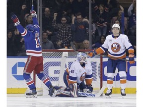 New York Rangers' Kevin Hayes, left, New York Islanders goaltender Robin Lehner, center, and New York Islanders' Ryan Pulock react after New York Rangers' Filip Chytil scored during the first period of the NHL hockey game, Wednesday, Nov. 21, 2018, in New York.