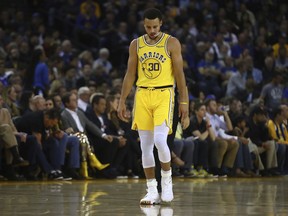 Golden State Warriors' Stephen Curry walks on the court during a timeout in the second half of the team's NBA basketball game against the Milwaukee Bucks on Thursday, Nov. 8, 2018, in Oakland, Calif.