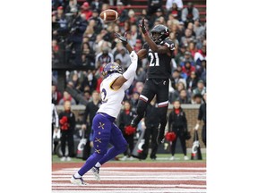 Cincinnati wide receiver Jayshon Jackson (21) scores a touchdown as East Carolina defensive back Khalil Barrett (22) defends during an NCAA college football game, Friday, Nov. 23, 2018, in Cincinnati.