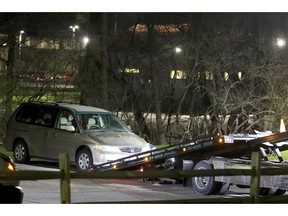FILE - In this April 10, 2018 file photo, a minivan is removed from the parking lot near the Seven Hills School campus in Cincinnati.  Findings and recommendations are coming from two companies hired by Cincinnati authorities for independent reviews into the failed response to Kyle Plush,  a 16-year-old student who died trapped in a minivan parked near his school. A special city council meeting is planned Thursday, Nov. 15,  for reports on the emergency center and police response.