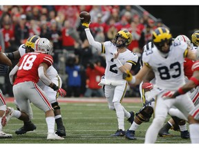 Michigan quarterback Shea Patterson throws a pass against Ohio State during the first half of an NCAA college football game Saturday, Nov. 24, 2018, in Columbus, Ohio.