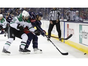 Dallas Stars' Gemel Smith, left, and Columbus Blue Jackets' Markus Hannikainen, of Finland, chase a loose puck during the first period of an NHL hockey game Tuesday, Nov. 6, 2018, in Columbus, Ohio.