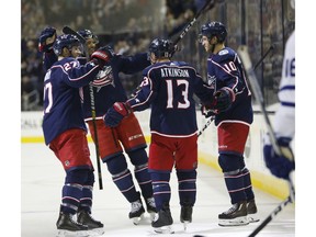 Columbus Blue Jackets players celebrate their goal against the Toronto Maple Leafs during the second period of an NHL hockey game Friday, Nov. 23, 2018, in Columbus, Ohio.