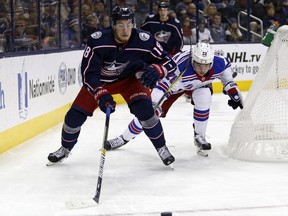 Columbus Blue Jackets forward Pierre-Luc Dubois, left, chases the puck against New York Rangers forward Jimmy Vesey during the first period of an NHL hockey game in Columbus, Ohio, Saturday, Nov. 10, 2018.