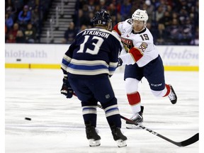 Florida Panthers defenseman Mike Matheson, right, shoots the puck against Columbus Blue Jackets forward Cam Atkinson during the first period of an NHL hockey game in Columbus, Ohio, Thursday, Nov. 15, 2018. Matheson scored on the play.