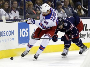 New York Rangers forward Pavel Buchnevich, left, of Russia, works against Columbus Blue Jackets defenseman David Savard during the first period of an NHL hockey game in Columbus, Ohio, Saturday, Nov. 10, 2018.