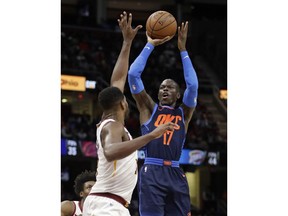 Oklahoma City Thunder's Dennis Schroeder, right, shoots over Cleveland Cavaliers' Tristan Thompson during the second half of an NBA basketball game Wednesday, Nov. 7, 2018, in Cleveland. The Thunder won 95-86.