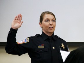 FILE - In this Aug. 10, 2017, file photo, former Tulsa police officer Betty Shelby is sworn in as a reserve deputy for the Rogers County Sheriffs Department in Claremore, Okla., at the Rogers County Courthouse. Civil rights leaders are calling for a homicide detectives group to rescind its invitation to speak to Shelby, a white Oklahoma law officer acquitted in the fatal shooting of an unarmed black man.