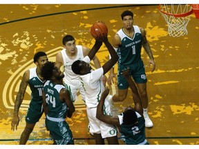 Oregon center Bol Bol goes up as teammate Payton Pritchard (3) watches along with Green Bay's Sandy Cohen III (1), PJ Pipes (2) and Jevon Smith (24) during the first half of their 2K Empire Classic NCAA college basketball game, Tuesday, Nov. 20 2018, in Eugene, Ore.