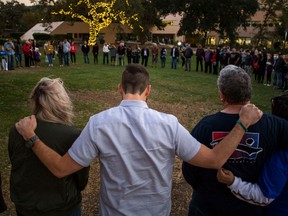 In this file photo taken on November 8, 2018, people gather during a vigil to pay tribute to the victims of a shooting in Thousand Oaks, California. - Susan Schmidt-Orfanos the mother of  Telemachus a 27-year US Navy veteran who survived last year's gun massacre in Las Vegas only to be killed by another gunman in a California bar this week, has made an impassioned plea for gun control. In a video clip that has gone viral on the internet, a distraught Schmidt-Orfanos rejected the habitual calls by politicians for "thoughts and prayers" after the shooting in Thousand Okas, Calfornia.