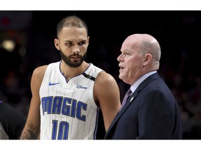 Orlando Magic guard Evan Fournier, left, speaks with head coach Steve Clifford during the first half of an NBA basketball game against the Portland Trail Blazers in Portland, Ore., Wednesday, Nov. 28, 2018.
