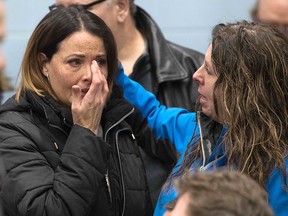 A Unifor union member cries before the press conference with union leaders in Oshawa, Ont., on Nov. 26, 2018. In a massive restructuring, U.S. auto giant General Motors announced it will cut 15 per cent of its workforce.
