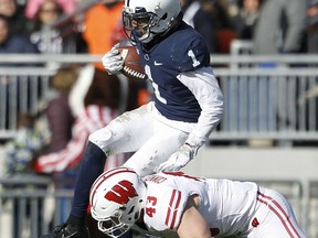 Penn State's KJ Hamler (1) gets hit by Wisconsin's Ryan Connelly (43) after a catch during the first half of an NCAA college football game in State College, Pa., Saturday, Nov. 10, 2018.