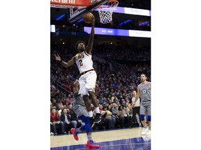 Cleveland Cavaliers' Collin Sexton, right, goes up for the shot past Philadelphia 76ers' Joel Embiid, left, of Cameroon, during the first half of an NBA basketball game, Friday, Nov. 23, 2018, in Philadelphia.