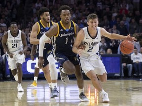 Villanova's Collin Gillespie, right, brings the ball up the court with Quinnipiac's Cameron Young, left, defending during the first half of an NCAA college basketball game Saturday, Nov. 10, 2018, in Philadelphia.