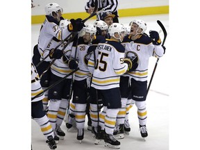 Buffalo Sabres' Jack Eichel, right, celebrates his game-winning overtime goal during an NHL hockey game against the Pittsburgh Penguins in Pittsburgh, Monday, Nov. 19, 2018. The Sabres won 5-4 in overtime.