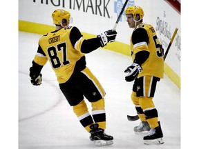 Pittsburgh Penguins' Jake Guentzel (59) celebrates with Sidney Crosby (87) after his goal during the first period of the team's NHL hockey game against the Dallas Stars in Pittsburgh, Wednesday, Nov. 21, 2018.