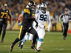 Pittsburgh Steelers quarterback Ben Roethlisberger (7) scrambles past Carolina Panthers defensive tackle Vernon Butler (92) during the second half of an NFL football game in Pittsburgh, Thursday, Nov. 8, 2018.