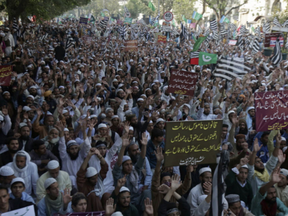 Supporters of a religious parties coalition, Muttahida Majlis-e-Amal Alliance, rally for the implementation of blasphemy law and against the acquittal of Pakistani Christian woman Aasia Bibi, in Lahore, Pakistan, Thursday, Nov.15, 2018. Bibi was acquitted and released after eight years on death row for blasphemy. Her whereabouts in Islamabad remained a closely guarded secret in the wake of demands by radical Islamists that she be publicly executed.