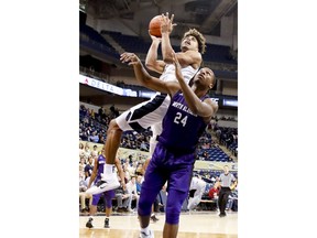 Pittsburgh's Malik Ellison, top, shoots over North Alabama's Kendall Stafford (24) during the first half of an NCAA college basketball game, Saturday, Nov. 17, 2018, in Pittsburgh.