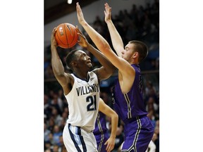 Villanova forward Dhamir Cosby-Roundtree (21) tries to get around Furman forward Matt Rafferty (32) during the first half of an NCAA college basketball game, Saturday, Nov. 17, 2018, in Villanova, Pa.