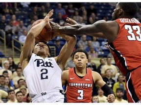 Pittsburgh guard Trey McGowens goes for a rebound against Youngstown State forward Naz Bohannon during the first half of an NCAA college basketball game Tuesday, Nov. 6, 2018, at Petersen Events Center in Pittsburgh.