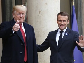 French President Emmanuel Macron, right, and U.S President Donald Trump thumb up at the Elysee Palace in Paris, Saturday, Nov.10, 2018. Trump is joining other world leaders at centennial commemorations in Paris this weekend to mark the end of World War I.