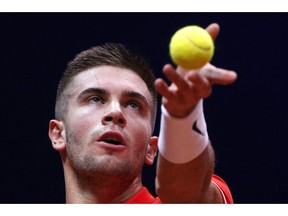 Croatia's Borna Coric serves the ball to France's Jeremy Chardy during the Davis Cup final between France and Croatia, Friday, Nov. 23, 2018 in Lille, northern France.