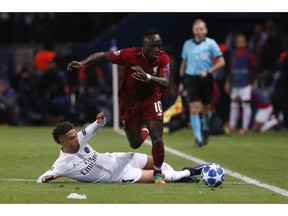 Liverpool midfielder Sadio Mane overruns PSG defender Thilo Kehrer during the Champions League Group C second leg soccer match between Paris Saint Germain and Liverpool at the Parc des Princes stadium in Paris, Wednesday, Nov. 28, 2018.