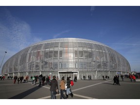 FILE - In this Saturday, Nov. 22, 2014 file photo, people walk outside the Pierre Mauroy stadium, in Lille, northern France. Yannick Noah guided France to Davis Cup titles in 1991, 1996 and 2017, but he will step down after this weekend and Amelie Mauresmo will take over. For his final match as captain of France Davis Cup team, Yannick Noah has been as meticulous as ever.