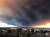 The massive plume from the Camp Fire, burning in the Feather River Canyon near Paradise, Calif., wafts over the Sacramento Valley as seen from Chico, Calif., on Nov. 8, 2018.