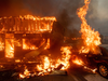 Flames consume a car and building as the Camp Fire tears through Paradise, Calif., on Nov. 8, 2018.