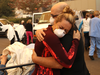 A hospital worker embraces her co-worker as they evacuate patients from the Feather River Hospital during the Camp Fire on Nov. 8, 2018 in Paradise, California.