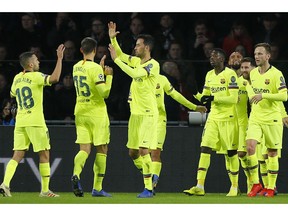 Barcelona players celebrate scoring their side's first goal during a Group B Champions League soccer match between PSV Eindhoven and Barcelona at the Philips stadium in Eindhoven, Netherlands, Wednesday, Nov. 28, 2018.