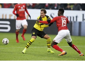 Mainz's Moussa Niakhate, right, and Dortmund's Mario Goetze, left, challenge for the ball during a German Bundesliga soccer match between FSV Mainz 05 and Borussia Dortmund in Mainz, Germany, Saturday, Nov. 24, 2018.