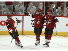 Arizona Coyotes right wing Michael Grabner (40) celebrates his goal against the Nashville Predators with defenseman Kevin Connauton (44) and center Brad Richardson (15) during the first period of an NHL hockey game Thursday, Nov. 15, 2018, in Glendale, Ariz.