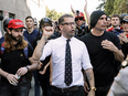 Gavin McInnes, centre, founder of the far-right group Proud Boys, surrounded by supporters in April 2017.