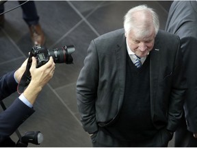 A photographer takes a picture as German Interior Minister Horst Seehofer attends a presentation of the Hasso Plattner Institute as part of a two-day retreat of the German government in Potsdam, near Berlin, Germany, Wednesday, Nov. 14, 2018.