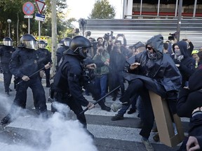 Police charge against protesters during a demonstration by CDR (Committees for the Defense of the Republic) in Barcelona, Spain, Saturday, Nov. 10, 2018. The so called Committees for the Defense of the Republic is a grassroots group that organise protests in Catalonia to press for their demand for independence.