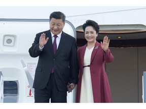 Chinese President Xi Jinping and his wife Peng Liyuan wave on arrival in Madrid, Spain, Tuesday Nov. 27, 2018.  Chinese president Xi Jinping has arrived Tuesday in Spain for the first leg of an international tour that will cover a global summit in Argentina and visits to Panama and Portugal.