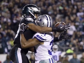 Philadelphia Eagles wide receiver Golden Tate, left, tries to make a catch as Dallas Cowboys cornerback Byron Jones defends during the second half of an NFL football game, Sunday, Nov. 11, 2018, in Philadelphia.