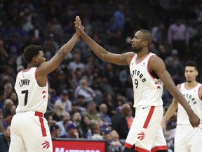 Toronto Raptors' Kyle Lowry, left, and Serge Ibaka give each other a high five during the second half of the Raptors 114-105 win over the Sacramento Kings in a NBA basketball game Wednesday, Nov. 7, 2018, in Sacramento, Calif.