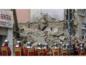Firefighters work at the scene where a building collapsed In Marseille, southern France, Monday, Nov. 5, 2018. A building collapsed in the southern city of Marseille on Monday, leaving a giant pile of rubble and beams. There was no immediate word on any casualties.