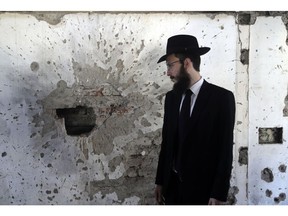 Rabbi Israel Kozlovsky, Director of Chabad House, stands near a partially destroyed wall of the Jewish center on the eve of the tenth anniversary of the Mumbai terror attacks in Mumbai, India, Sunday, Nov 25, 2018. On Nov. 26, 2008, India's financial capital Mumbai was turned into a war zone by a group of Pakistani gunmen who launched coordinated attacks in the heart of the city. They targeted two luxury hotels, a Jewish center, a tourist restaurant and a crowded train station. Three days of carnage killed 166 people, including foreign tourists, and wounded hundreds more.