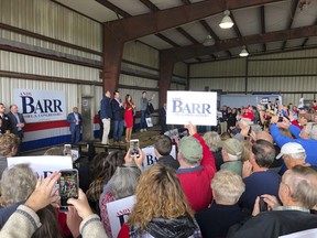 Donald Trump Jr., center, and former Fox News host Kimberly Guilfoyle, right, urge a crowd of supporters to vote for U.S. Rep. Andy Barr, left, at a rally on Monday, Nov. 5, 2018, in Mount Sterling, Ky. Barr is in a tight race for in Kentucky's 6th Congressional district against Democrat Amy McGrath.