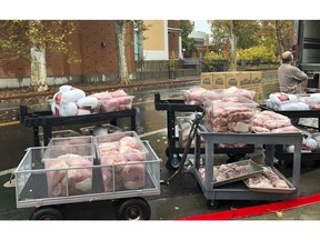 Hundreds of frozen turkeys are unloaded on the campus of California State University, in Chico, Calif., Wednesday, Nov. 21, 2018. The nonprofit World Central Kitchen is preparing them for a Thanksgiving meal for residents displaced by the Camp Fire in Northern California. The fire ignited Nov. 8 and devastated Paradise, Calif., and surrounding communities.