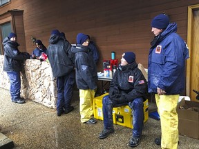 National Urban Search & Rescue Response System Orange County CATF-5 team members Imelda Cordova, third from right, talks Andrew Ricker, and Craig Stevens, far right, as their team take cover from the rain in Paradise, Calif., Friday, Nov. 23, 2018. High winds and heavy rains are temporarily halting the work of some search teams out looking for remains of people caught up in the deadly wildfire. The Camp Fire, which destroyed the historical mining town of Paradise, is the most deadly in state history, with 84 fatalities as of Friday, according to statistics from the California Department of Forestry and Fire Protection. It's also the deadliest in the U.S. in a century.