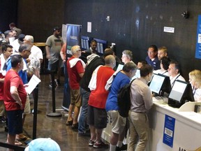 This July 14, 2018 file photo shows gamblers placing bets on sports events at the FanDuel sports book at the Meadowlands Racetrack in East Rutherford, N.J., on the day it opened. On Nov. 30, 2018, FanDuel paid out bets on Alabama to win the national college football championship a month before the game is played.